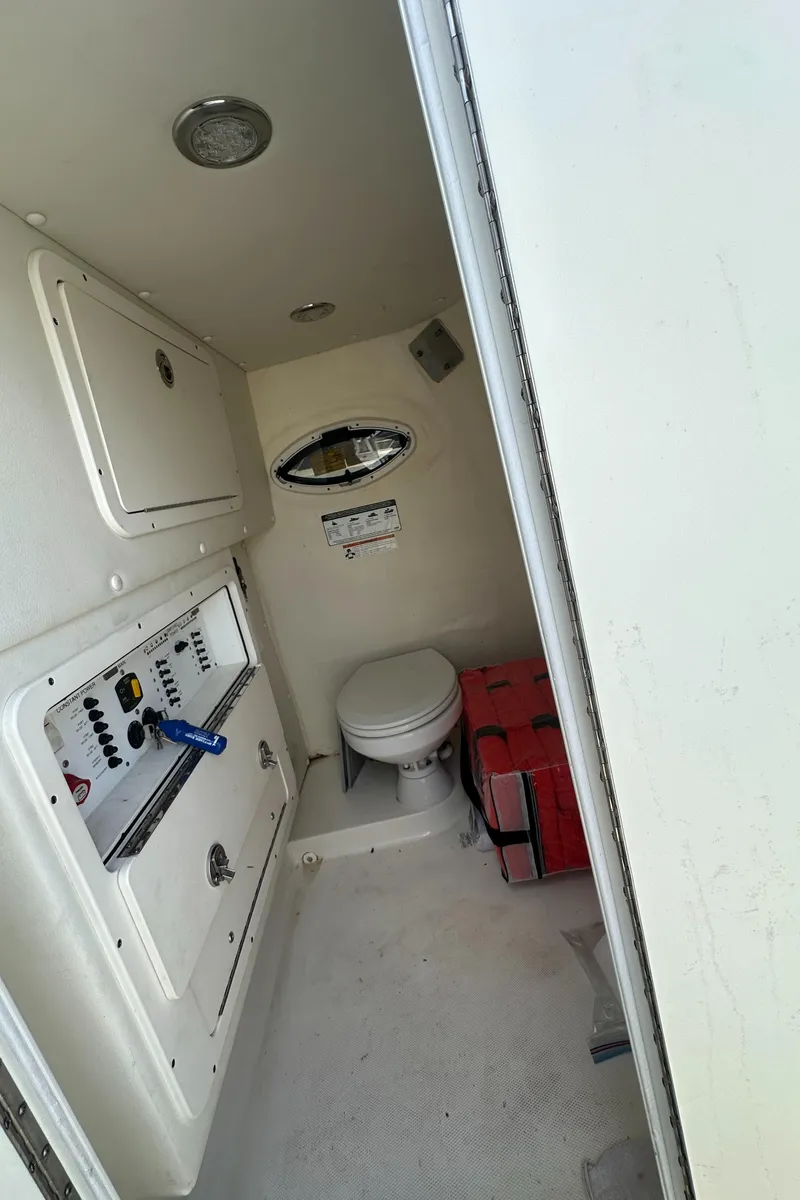 Slide: The Image of Interior of 2020 World Cat 325 CC boat with toilet and control panel. - 16