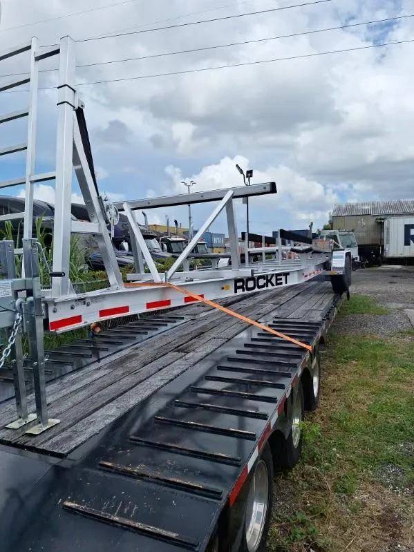 Slide: The Image of Trailer carrying a 2020 World Cat 325 CC boat frame, parked outdoors. - 20