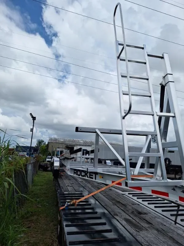 Slide: The Image of 2020 World Cat 325 CC boat on trailer under cloudy sky. - 21