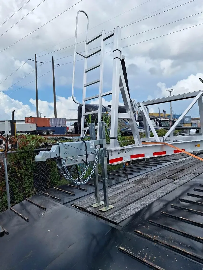 Slide: The Image of 2020 World Cat 325 CC boat trailer with ladder under cloudy sky. - 22