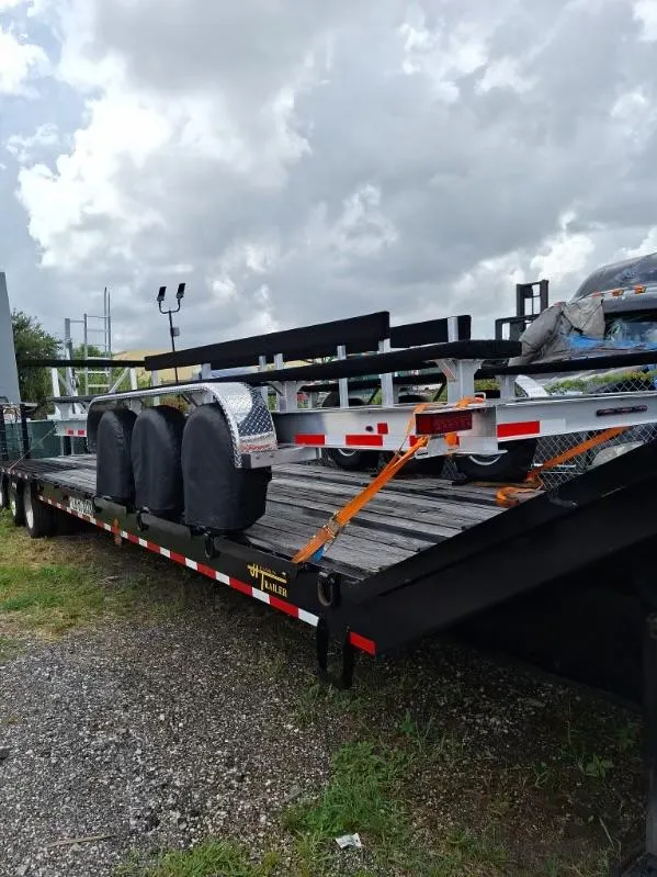 Slide: The Image of Trailer carrying a 2020 World Cat 325 CC boat under cloudy skies. - 24
