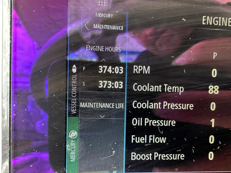 Slide: The Image of Display screen showing engine hours and metrics on a 2020 World Cat 325 CC boat. - 4