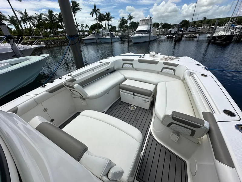Slide: The Image of 2020 World Cat 325 CC boat with spacious seating in a marina setting. - 7