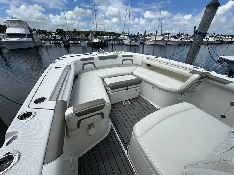 Slide: The Image of 2020 World Cat 325 CC boat with spacious seating at marina. - 8