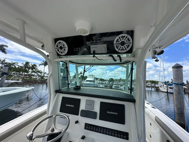 Slide: The Image of 2020 World Cat 325 CC boat cockpit with Garmin displays, docked at marina. - 9