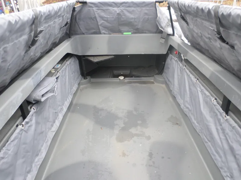 Slide: The Image of Interior of 2024 Bankes Freedom 17 boat with gray seating and storage compartments. - 3