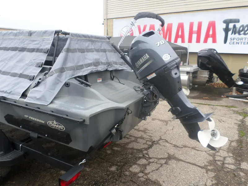 Slide: The Image of 2024 Bankes Freedom 17 boat with Yamaha 70 outboard motor, parked at dealership. - 5