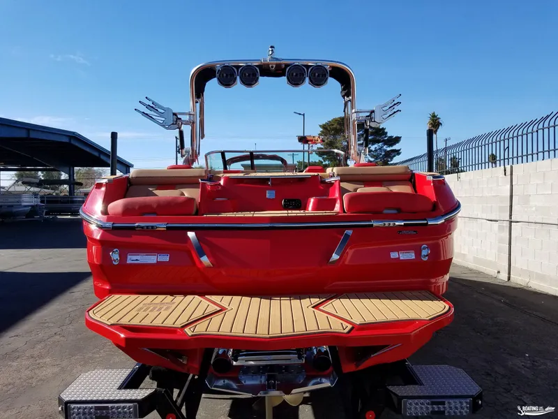 Slide: The Image of 2021 MasterCraft X26 boat, red exterior, rear view, parked on trailer. - 11