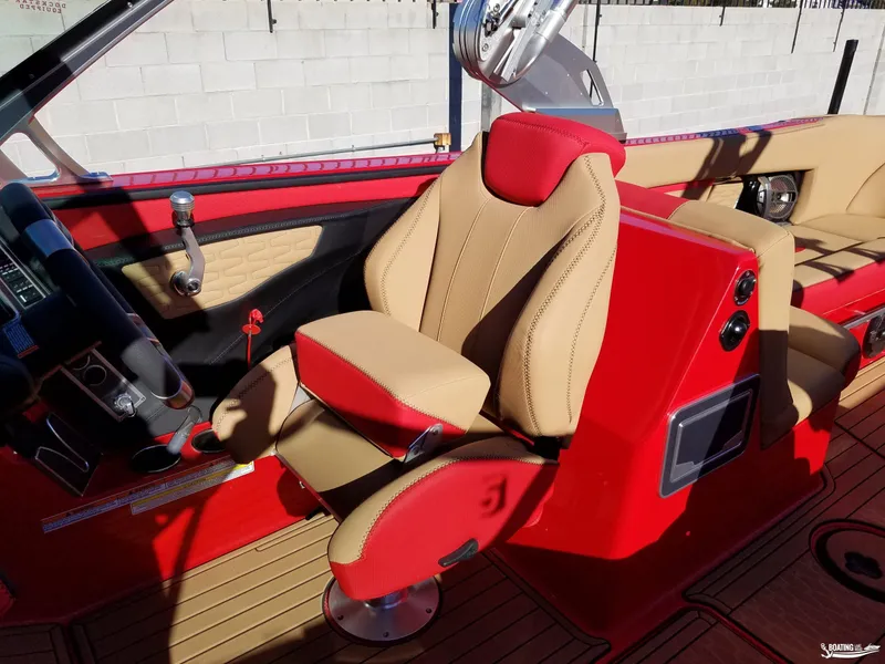 Slide: The Image of 2021 MasterCraft X26 boat interior with red and beige seating. - 16