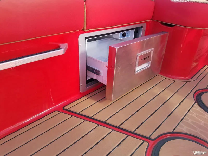 Slide: The Image of 2021 MasterCraft X26 boat with open Dometic drawer fridge, red seating, and teak flooring. - 17