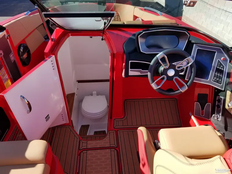 Slide: The Image of 2021 MasterCraft X26 boat interior with helm and cabin toilet. - 18