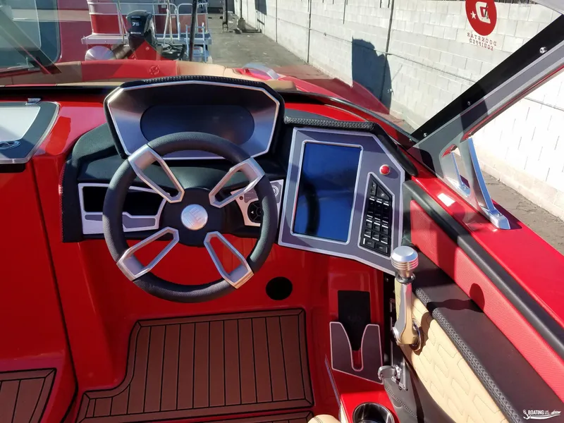 Slide: The Image of 2021 MasterCraft X26 boat dashboard with modern steering and touchscreen controls. - 19