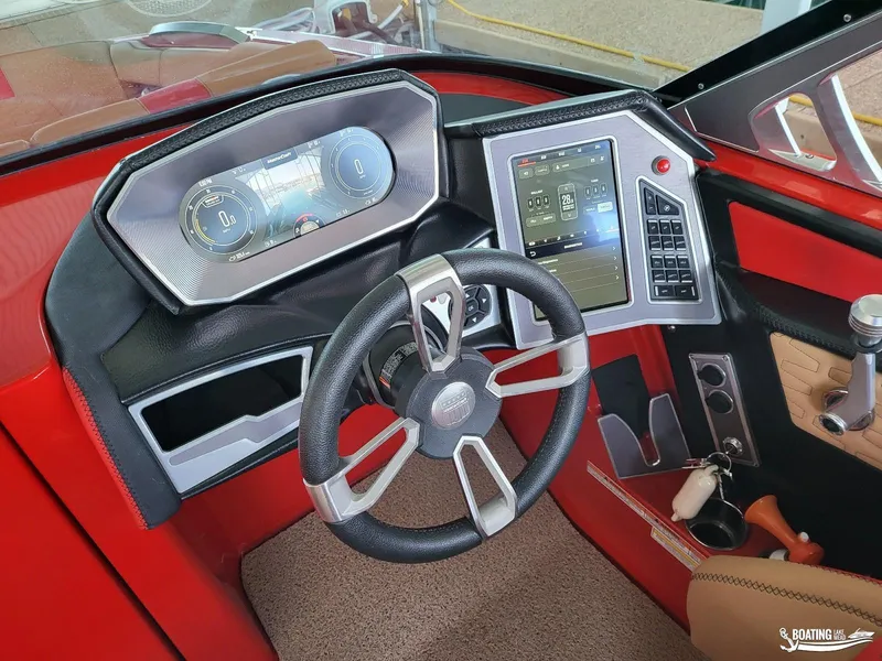 Slide: The Image of 2021 MasterCraft X26 boat dashboard with modern steering and digital controls. - 20