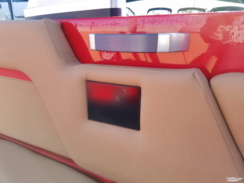 Slide: The Image of 2021 MasterCraft X26 boat interior with beige upholstery and red accents. - 27