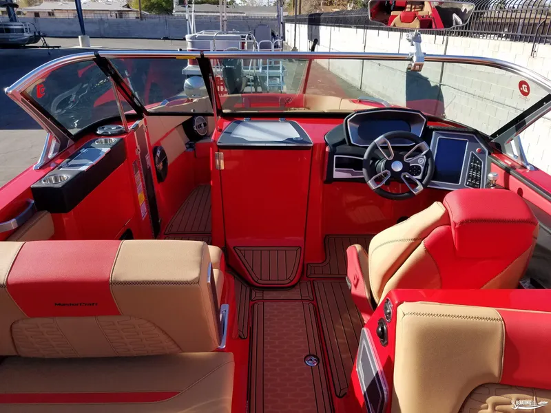 Slide: The Image of Interior of 2021 MasterCraft X26 boat with red and beige seating, modern dashboard. - 30