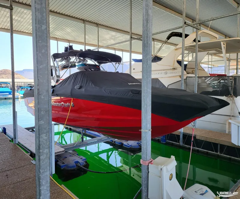 Slide: The Image of 2021 MasterCraft X26 boat in marina, covered and docked. - 37