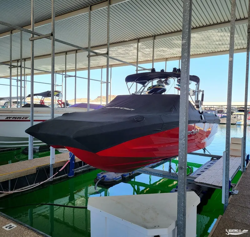 Slide: The Image of 2021 MasterCraft X26 boat docked with cover in marina. - 38