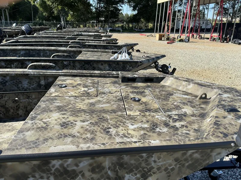 Slide: The Image of Row of 2025 Excel Viper F4 1554 ECLIPSE boats with camouflage design in outdoor setting. - 3