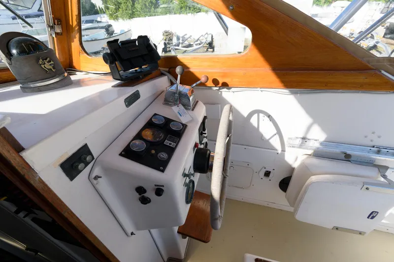 Slide: The Image of 1983 Dyer 29 Downeast Express boat cockpit with steering wheel and control panel. - 11