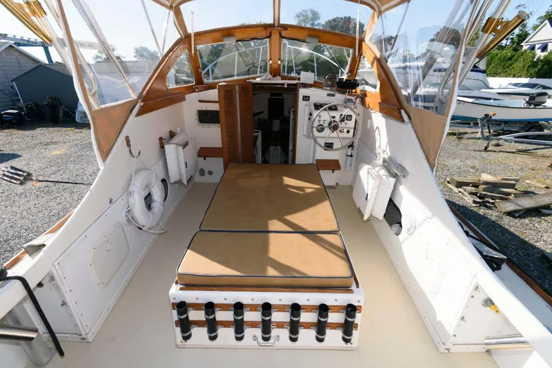 Slide: The Image of 1983 Dyer 29 Downeast Express boat interior with seating and navigation equipment. - 12