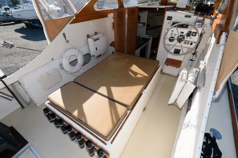 Slide: The Image of 1983 Dyer 29 Downeast Express boat interior with helm and seating area. - 13