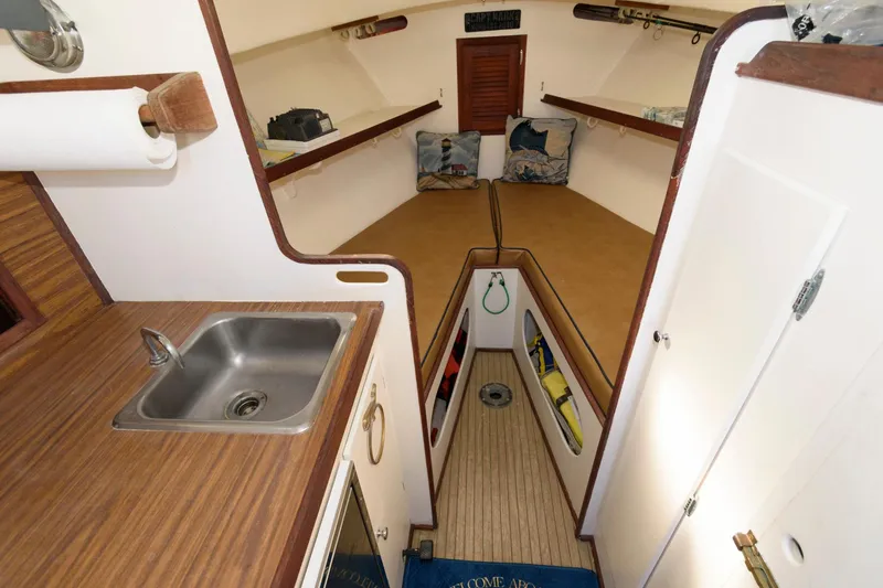 Slide: The Image of Interior of 1983 Dyer 29 Downeast Express boat with sink and cozy cabin space. - 16