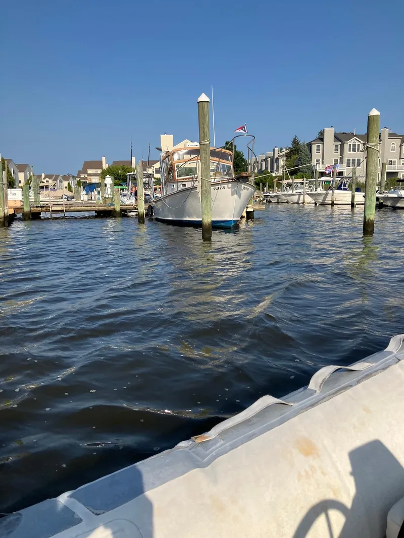 Slide: The Image of 1983 Dyer 29 Downeast Express docked in a sunny marina. - 2