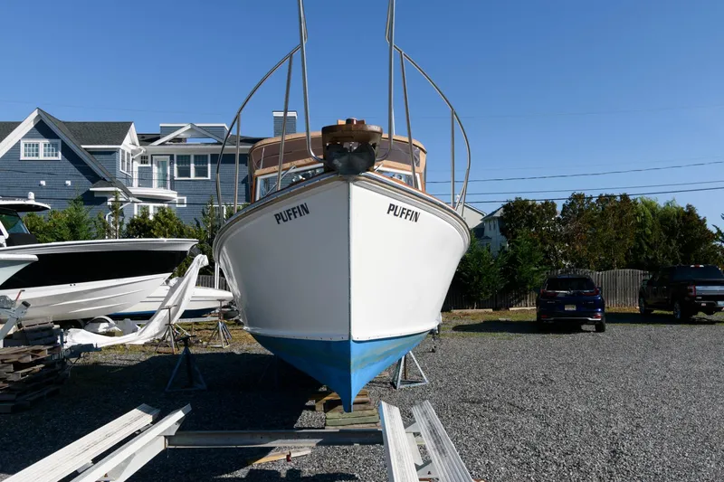 Slide: The Image of 1983 Dyer 29 Downeast Express boat named Puffin on a trailer, residential background. - 7