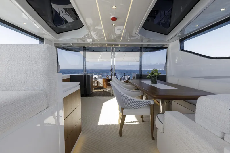 Slide: The Image of Luxurious interior of 2023 Mangusta Gransport yacht with ocean view and elegant dining area. - 10