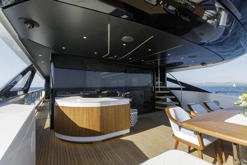 Slide: The Image of Luxurious 2023 Mangusta Gransport yacht deck with elegant seating and ocean view. - 13