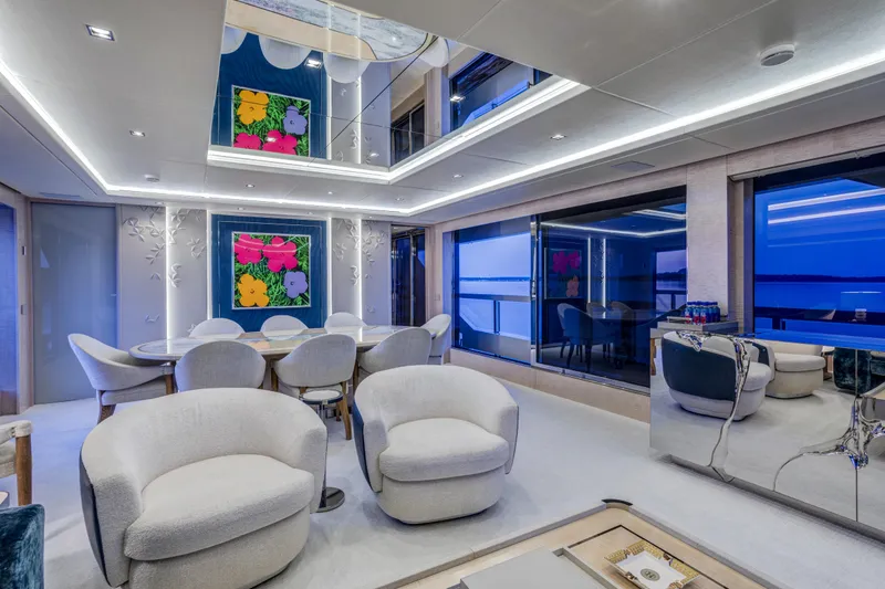 Slide: The Image of Luxurious 2023 Mangusta Gransport yacht interior with modern seating and vibrant artwork. - 16