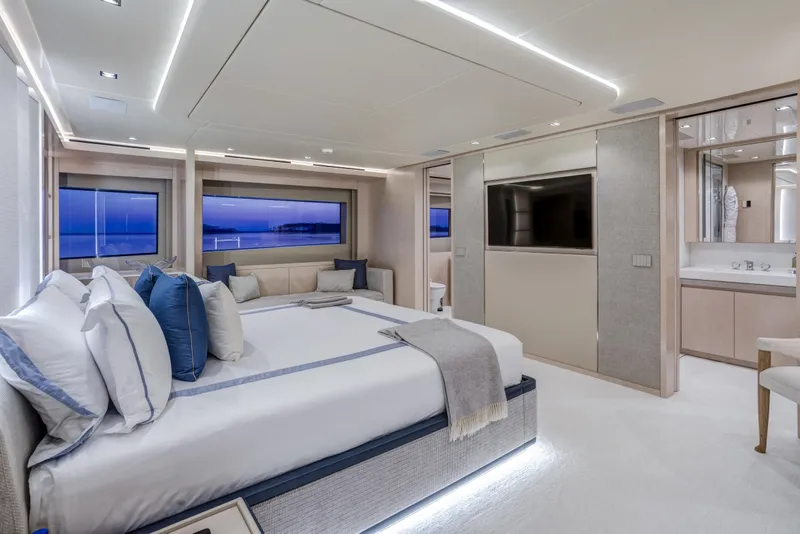 Slide: The Image of Luxurious 2023 Mangusta Gransport yacht bedroom with elegant decor and ocean views. - 18