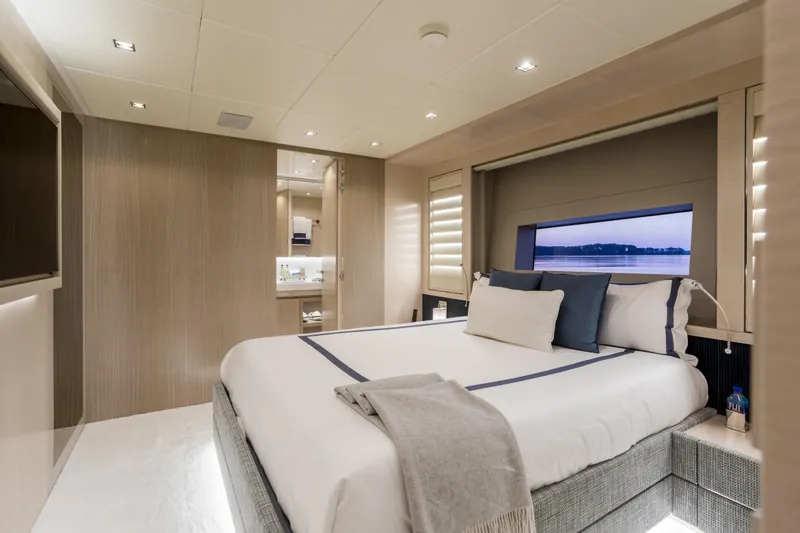 Slide: The Image of Luxurious bedroom interior of 2023 Mangusta Gransport yacht with modern design and elegant furnishings. - 24