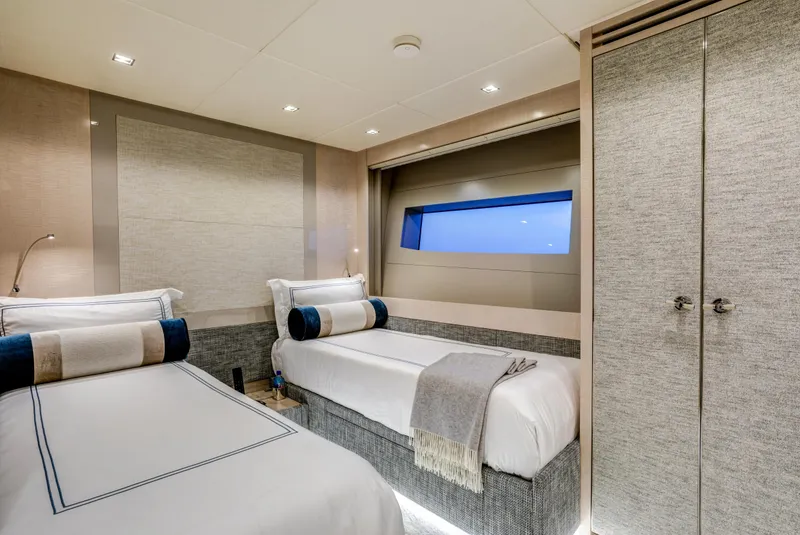 Slide: The Image of Luxurious 2023 Mangusta Gransport yacht cabin with twin beds and modern decor. - 25