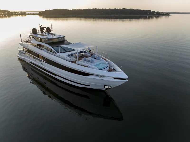 Slide: The Image of Luxurious 2023 Mangusta Gransport yacht cruising on serene waters at sunset. - 3