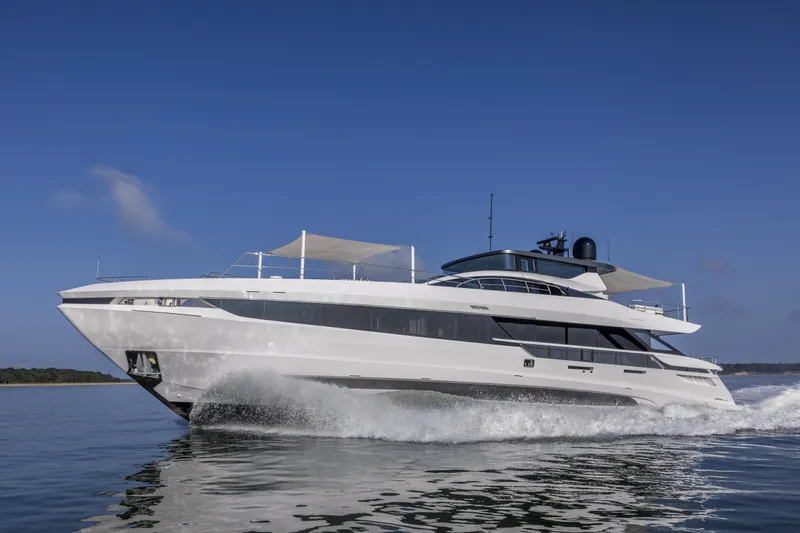Slide: The Image of 2023 Mangusta Gransport yacht cruising on open water under clear blue sky. - 35