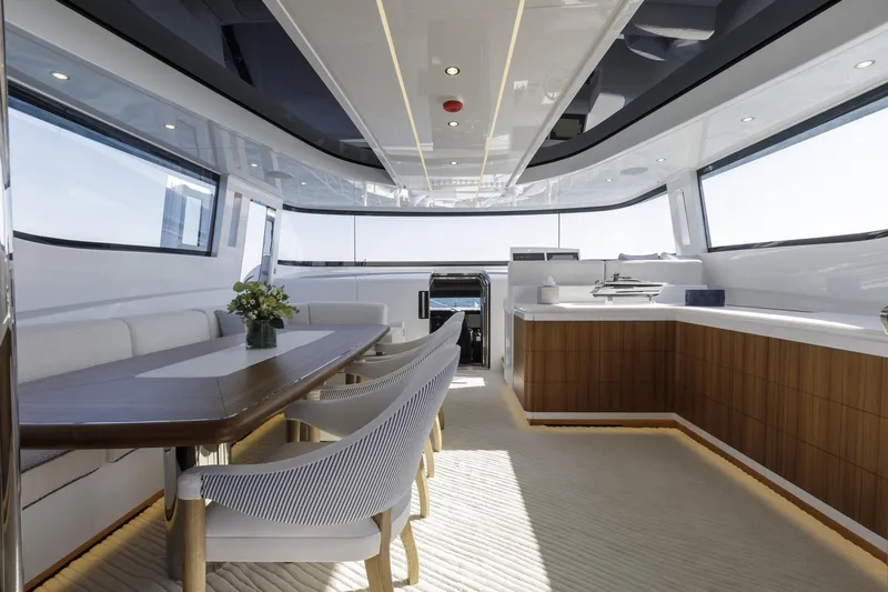Slide: The Image of Luxurious interior of 2023 Mangusta Gransport yacht with elegant dining area and panoramic windows. - 9