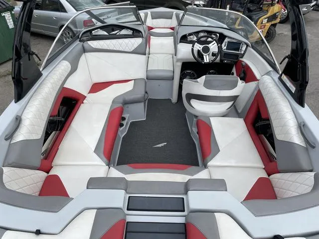 Slide: The Image of 2015 Tigé Z1 boat interior with red and white seating, modern dashboard, and spacious layout. - 4