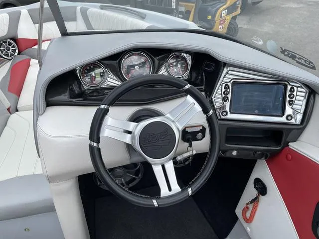 Slide: The Image of 2015 Tigé Z1 boat dashboard with steering wheel and control panel. - 5
