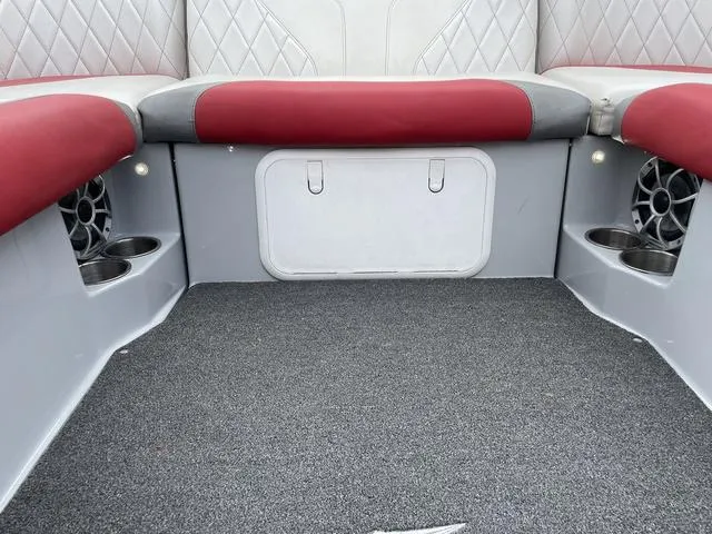 Slide: The Image of 2015 Tigé Z1 boat interior with red and gray seating, cup holders, and speakers. - 8