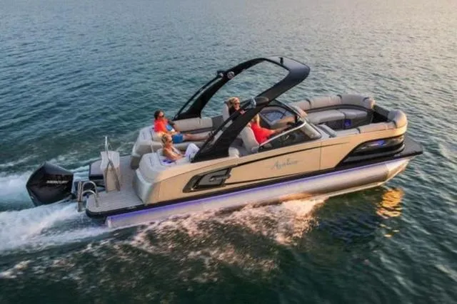 Slide: The Image of 2025 Avalon Excalibur LTD Quad Lounge boat cruising on open water. - 1