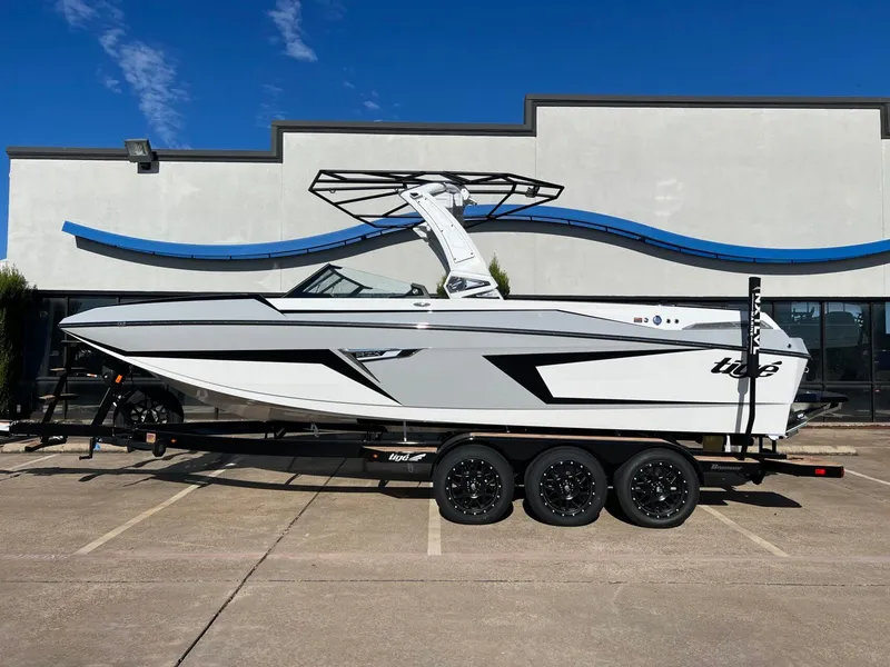 Slide: The Image of 2025 Tigé 24RZX boat on trailer, sleek design, parked outdoors. - 1
