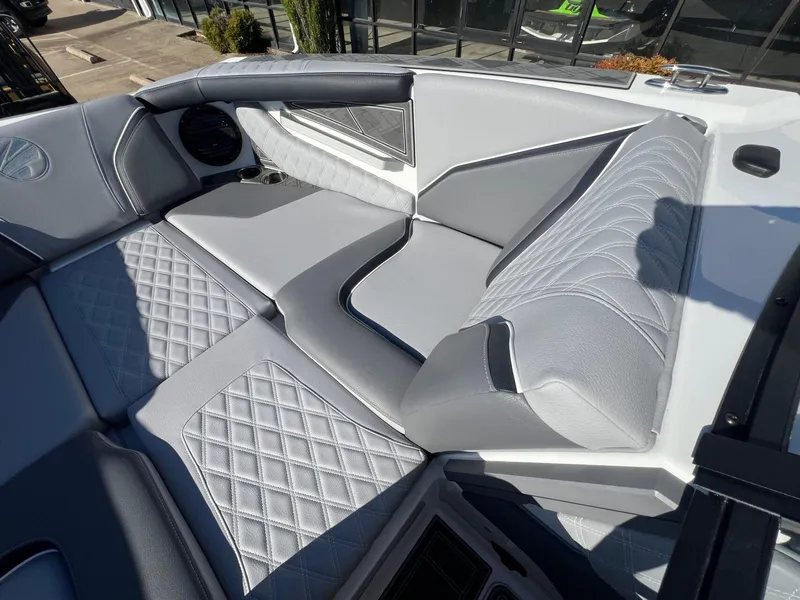 Slide: The Image of 2025 Tigé 24RZX boat interior with luxurious gray quilted seating. - 14