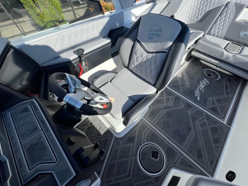 Slide: The Image of 2025 Tigé 24RZX boat interior with sleek steering wheel and modern seating design. - 15