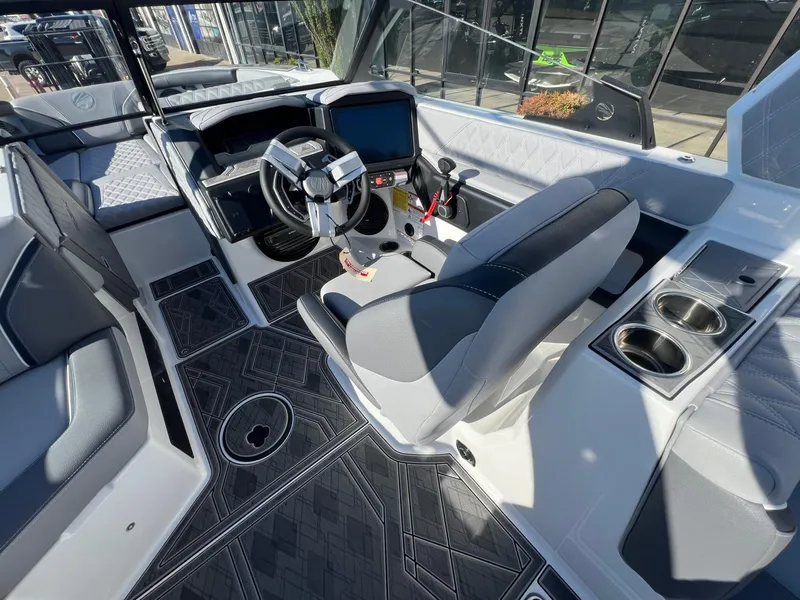 Slide: The Image of Interior of 2025 Tigé 24RZX boat, featuring modern steering and seating. - 16