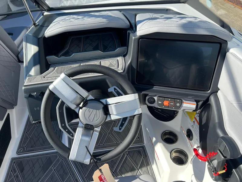 Slide: The Image of 2025 Tigé 24RZX boat dashboard with steering wheel and touchscreen display. - 17