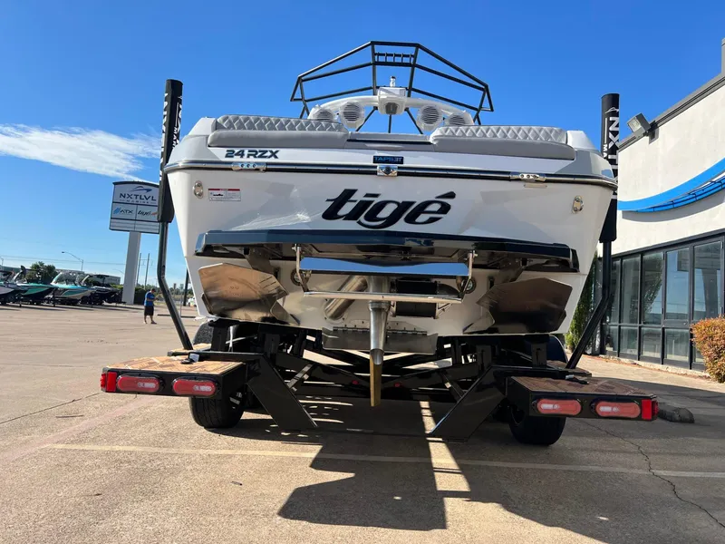 Slide: The Image of 2025 Tigé 24RZX boat on trailer, rear view, sunny day at dealership. - 5