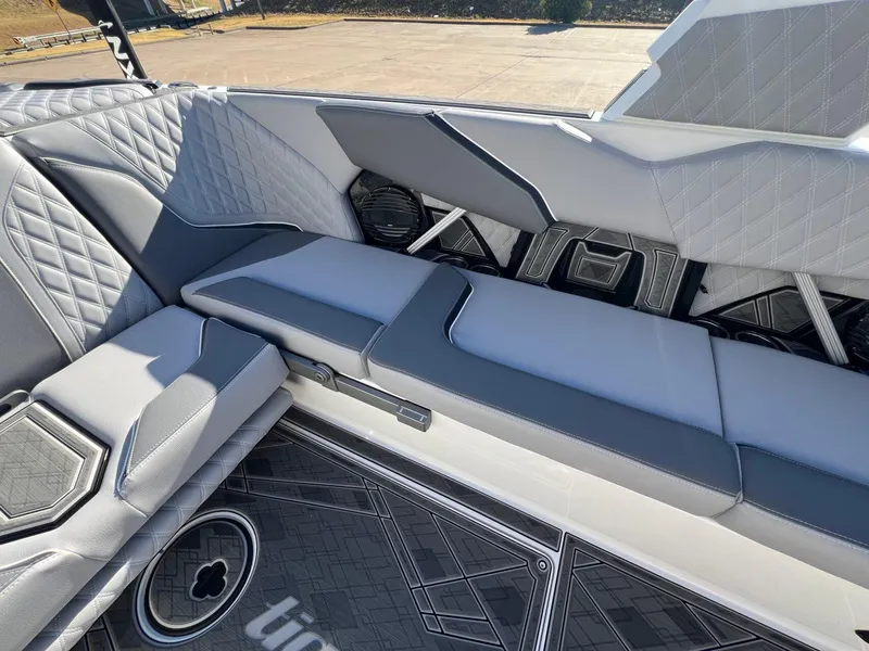Slide: The Image of 2025 Tigé 24RZX boat interior with gray quilted seating and stylish flooring. - 9