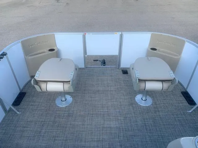 Slide: The Image of 2023 SunCatcher Select 18F boat interior with two beige swivel seats. - 10
