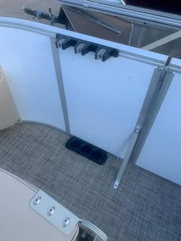 Slide: The Image of Interior of 2023 SunCatcher Select 18F boat with cup holders and carpeted flooring. - 13